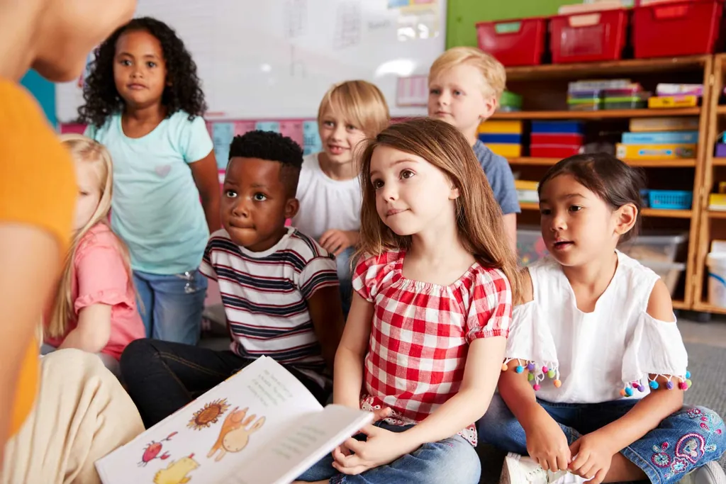 A young student practices early reading with guidance.