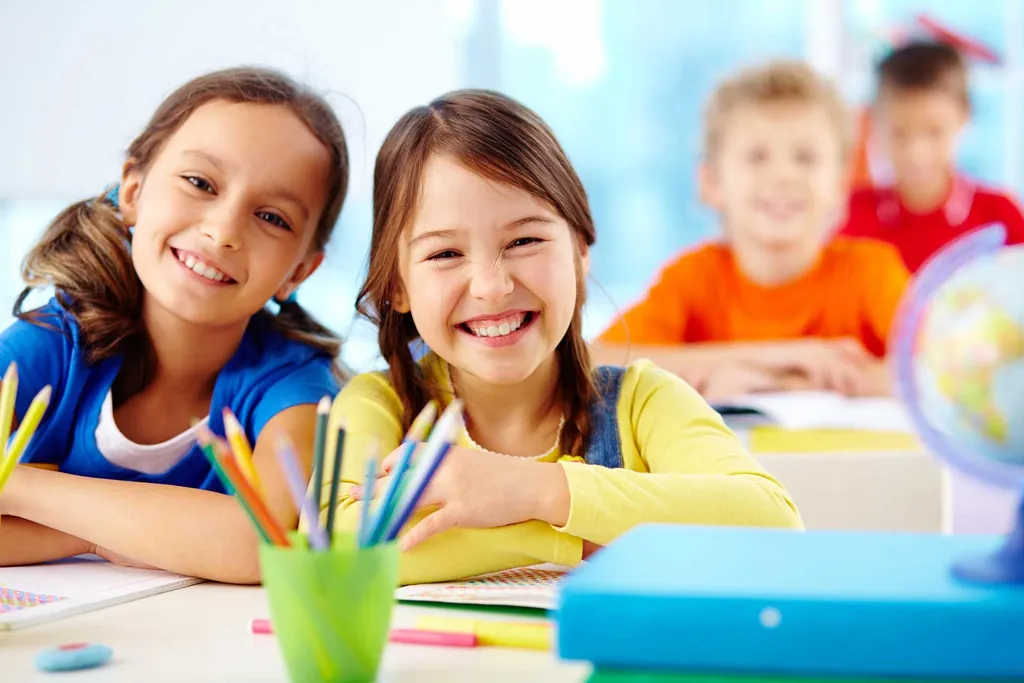 A tutor works one-on-one with a young student at a learning table.
